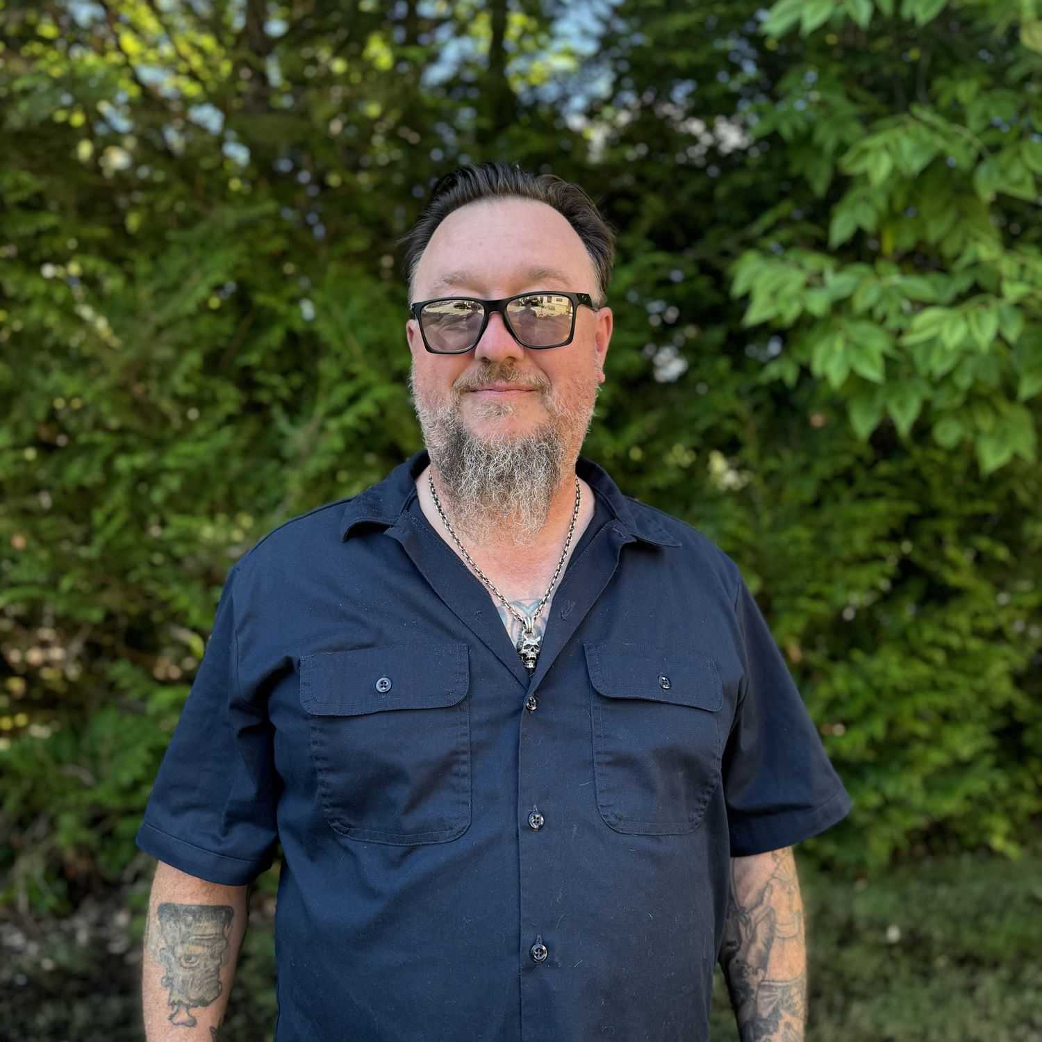 Portrait of Khristian Hansen, a professional stylist at Robert Allan Salon, showcasing their expertise and style.